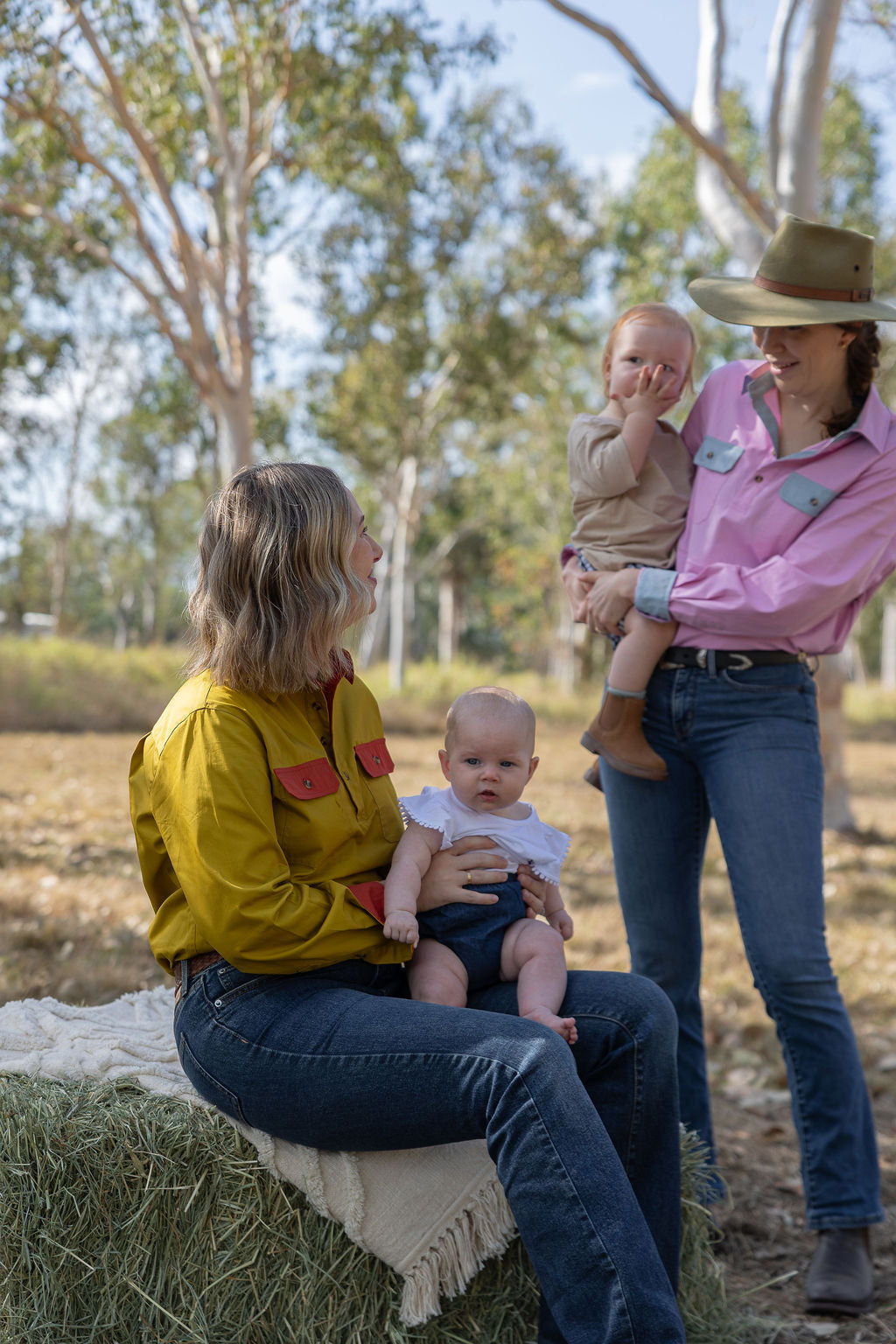 Mums wearing breastfeeding work shirt holding babies