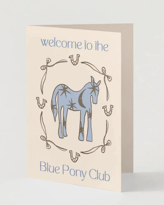 Greeting card with a blue pony illustration and text 'welcome to the Blue Pony Club' on a beige background.