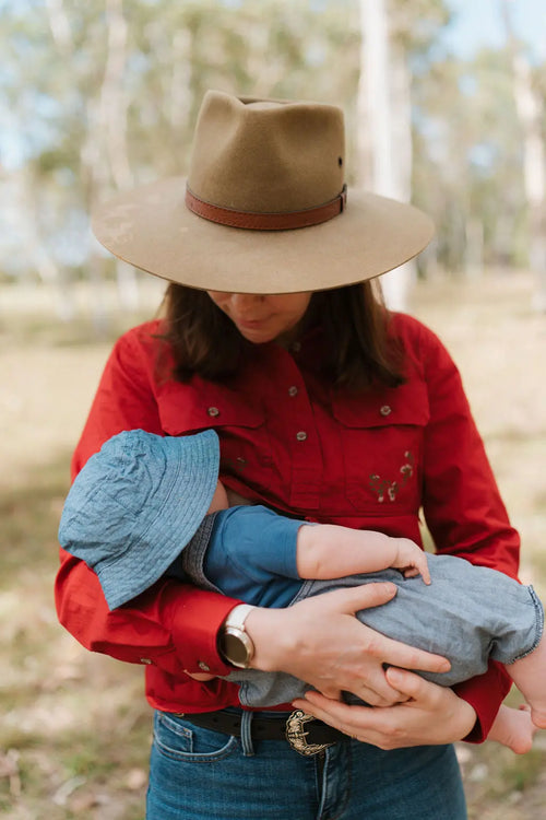 Mum nursing baby in a breastfeeding shirt