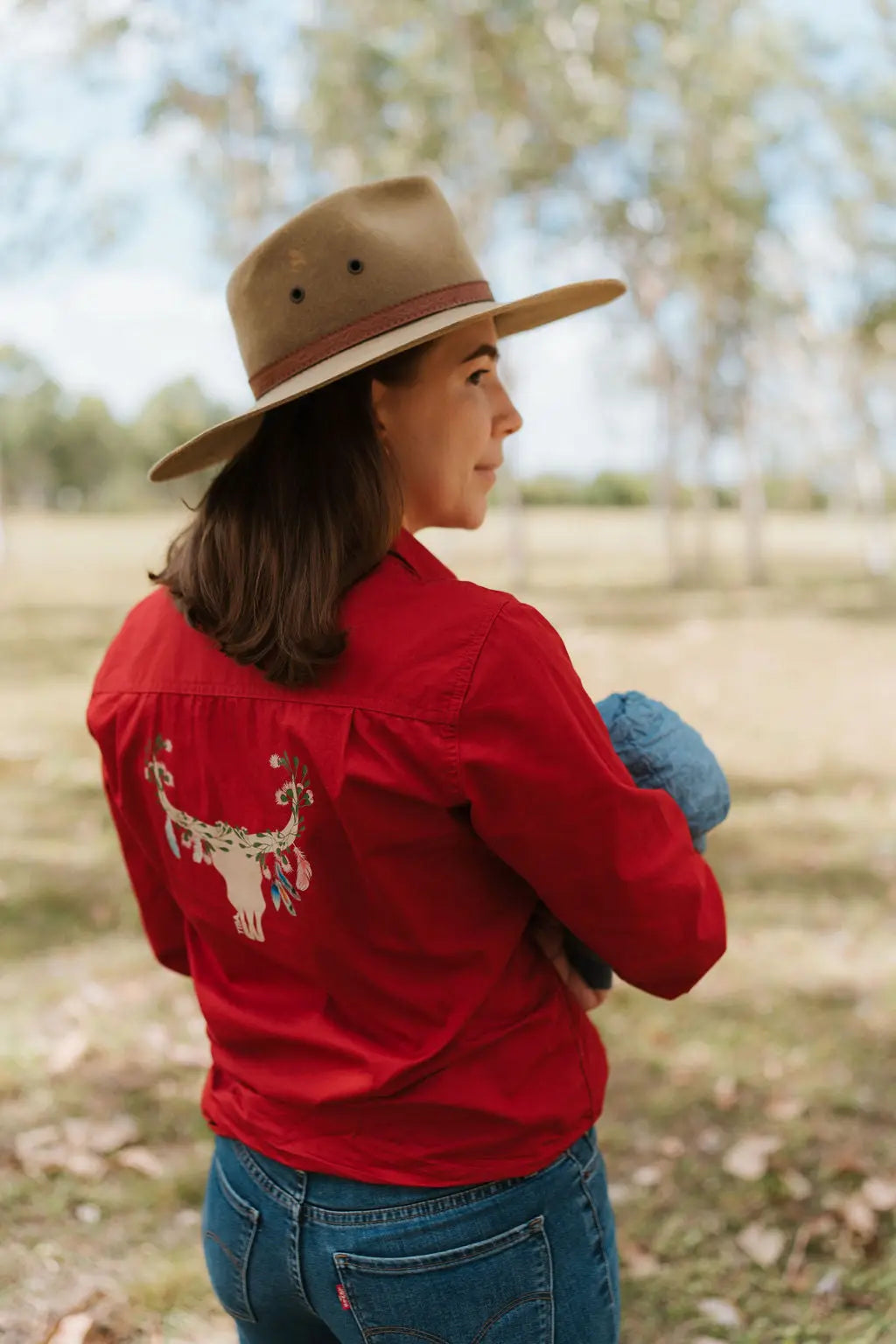 Mum standing with baby wearing hat in the outdoors