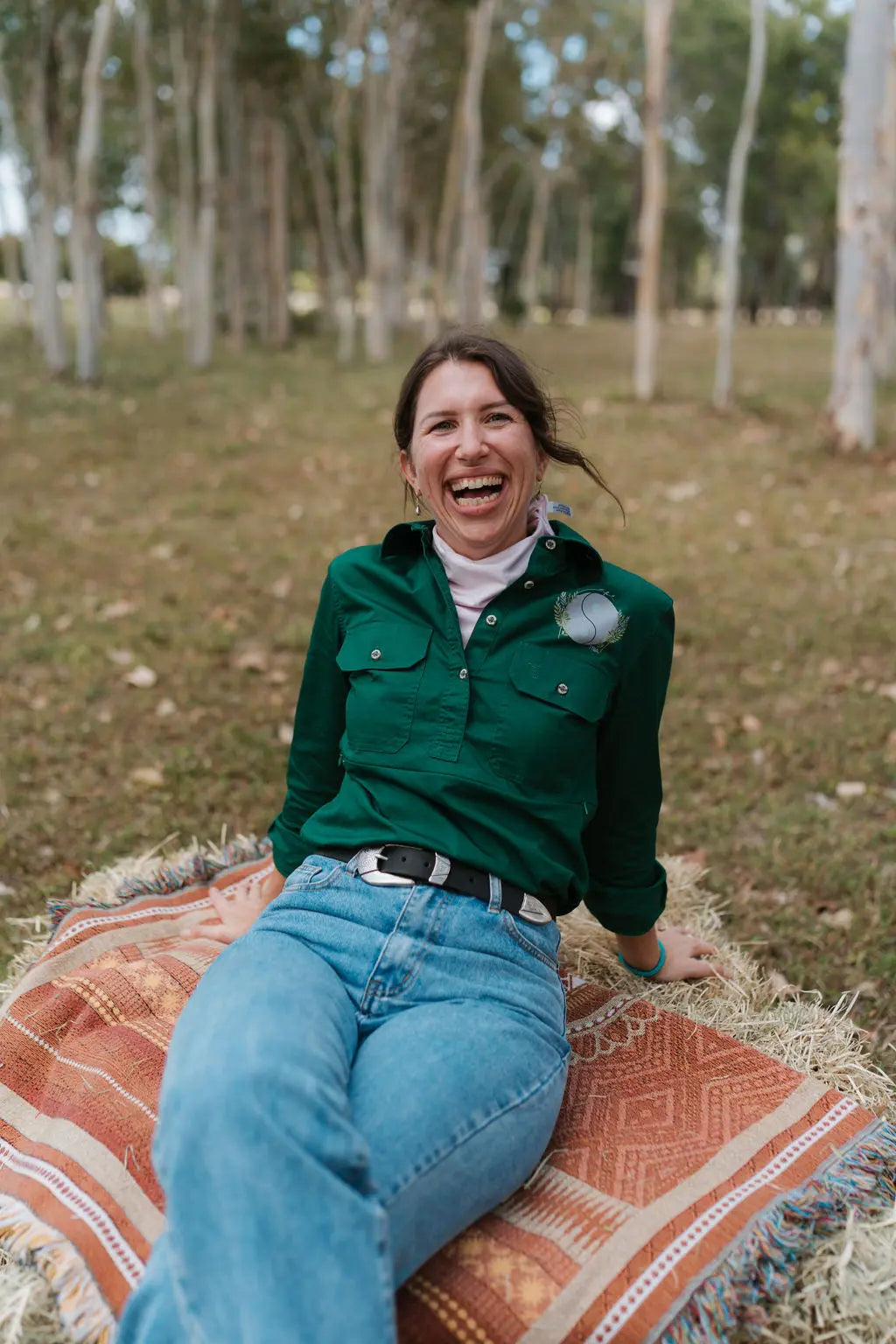 Lady sitting on hay bale wearing breastfeeding shirt