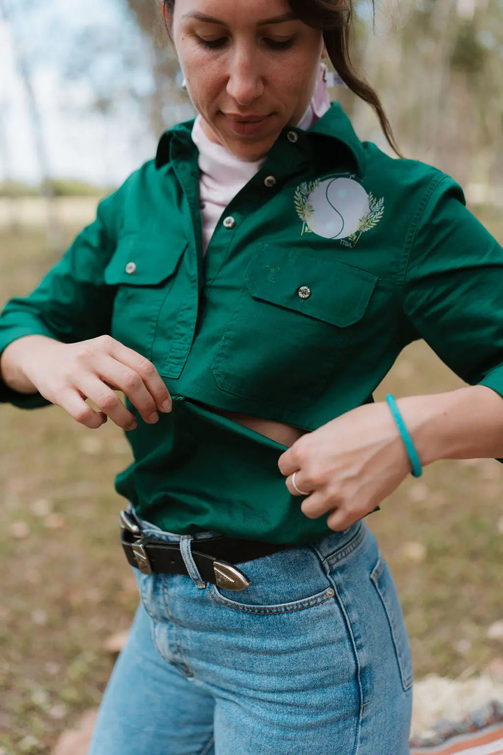 Woman unzipping her breastfeeding shirt with two way zip