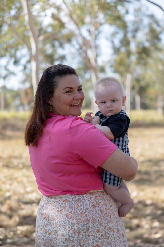 Mum holding baby wearing TittyTees breastfeeding shirt in Gumnuts