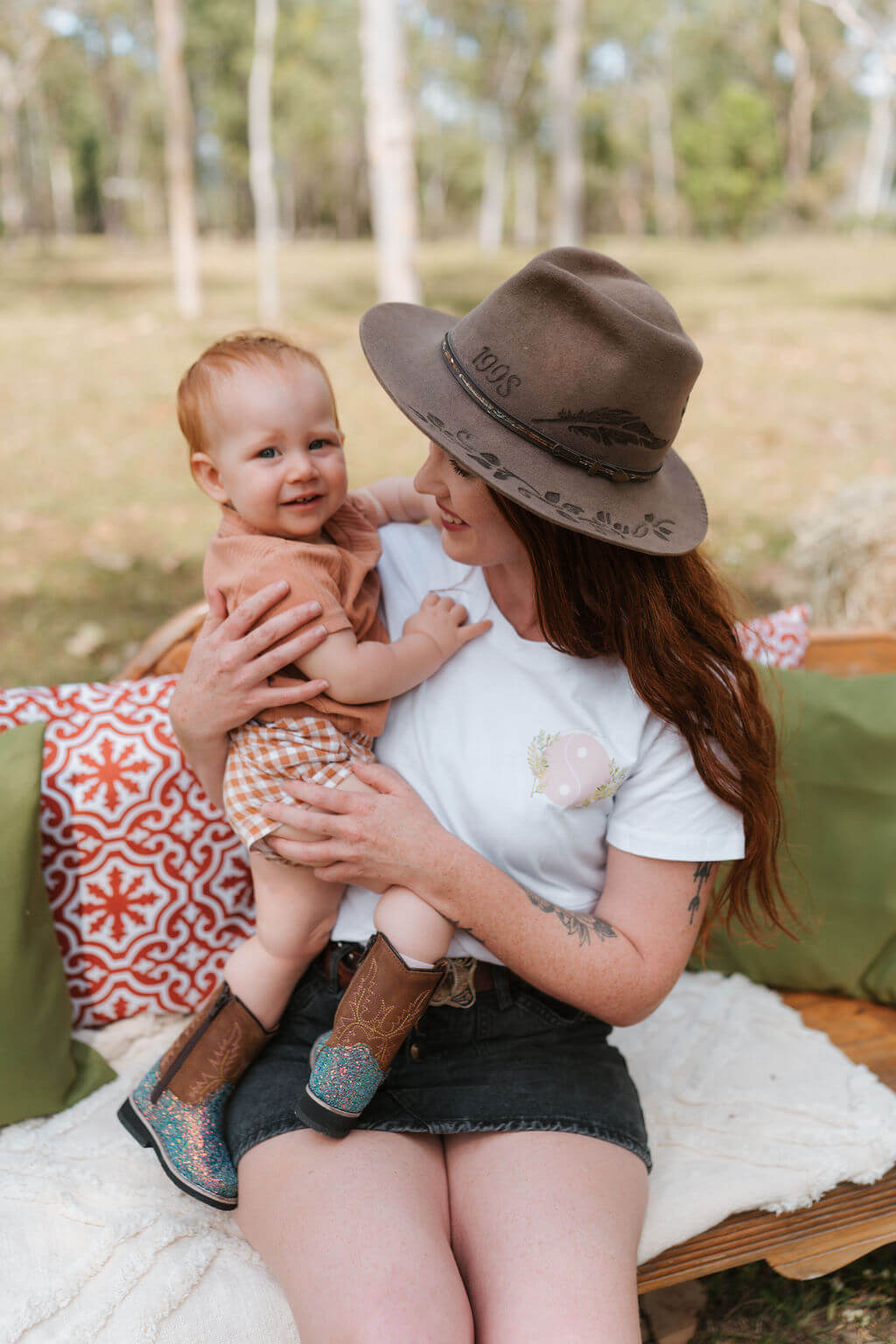 Mum holding toddler outdoors