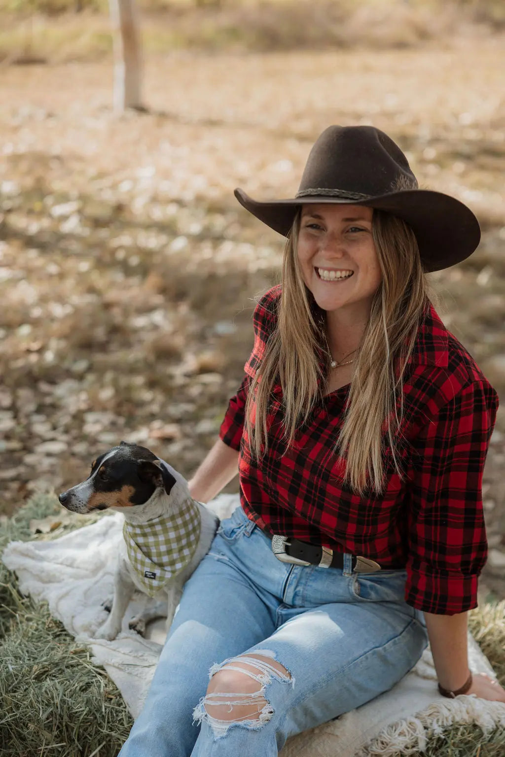 Outdoors sitting on hay bale with jack Russel dog wearing Long sleeve breastfeeding Fannette shirt