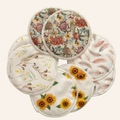 Set of floral and nature-themed reusable pads on a white background