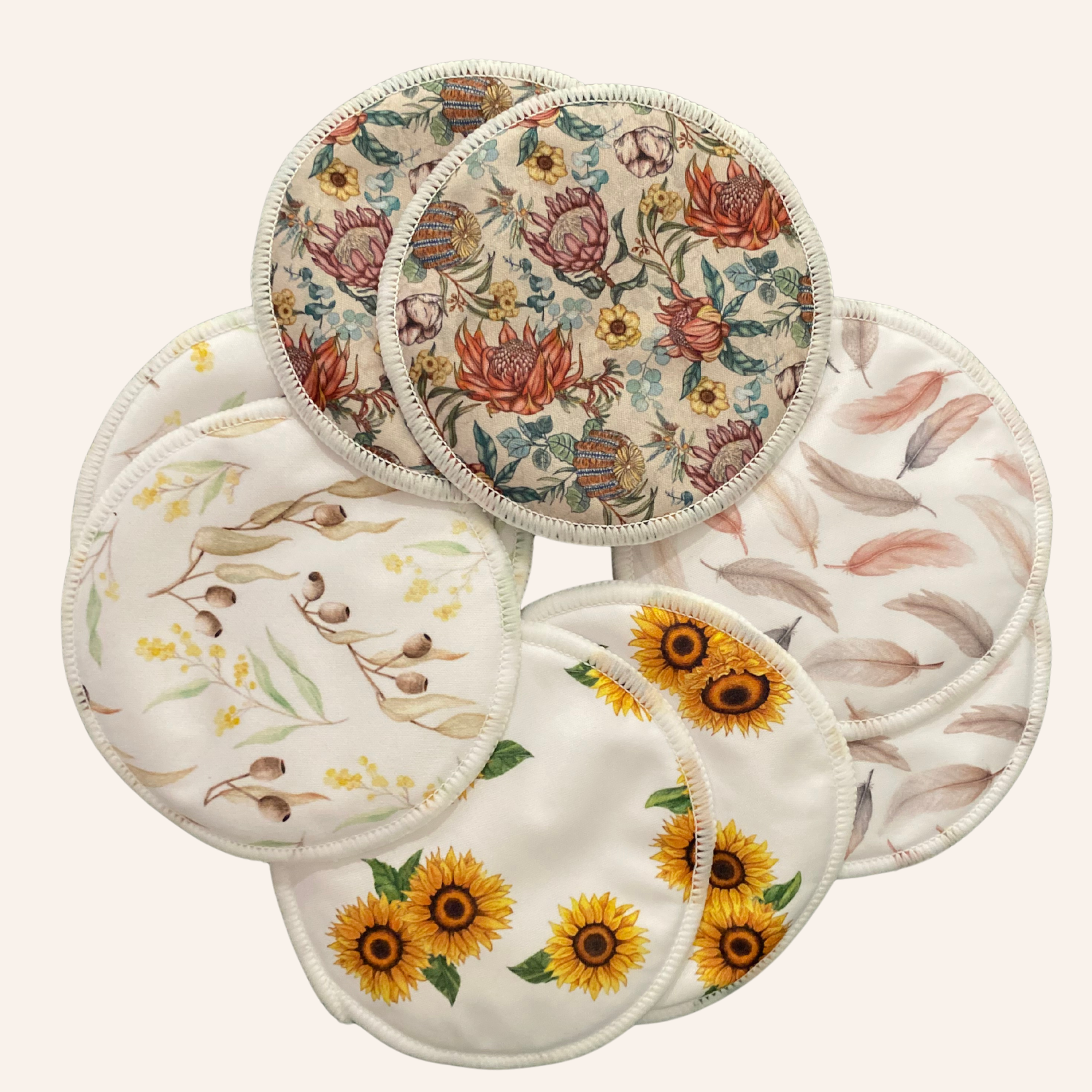 Set of floral and nature-themed reusable pads on a white background