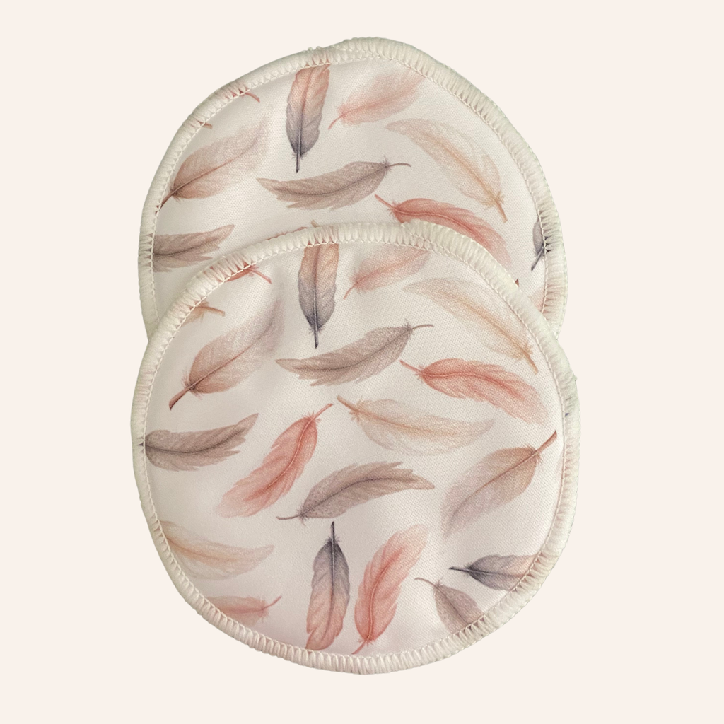 Two round pads with feather pattern on a white background