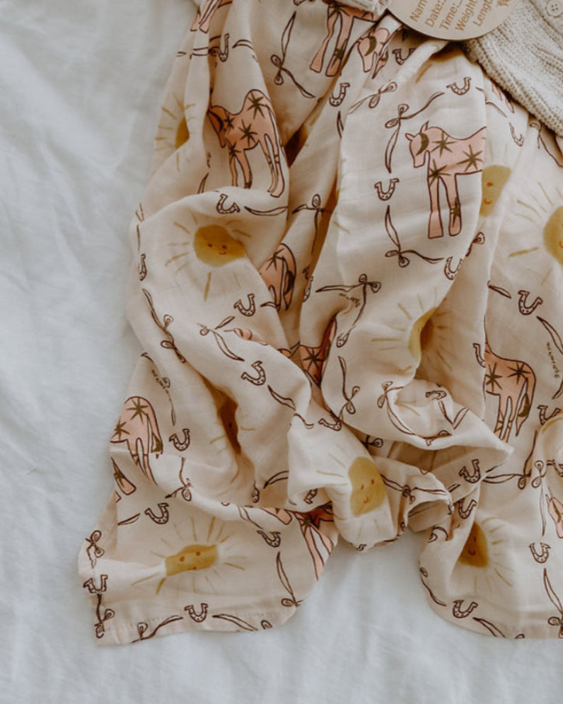Baby wrap with pink pony print ruffeled up 
