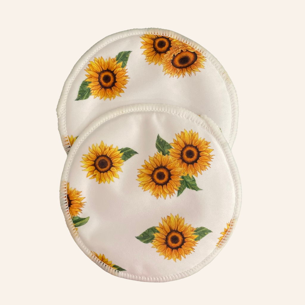 Two round fabric pads with sunflower pattern on a white background