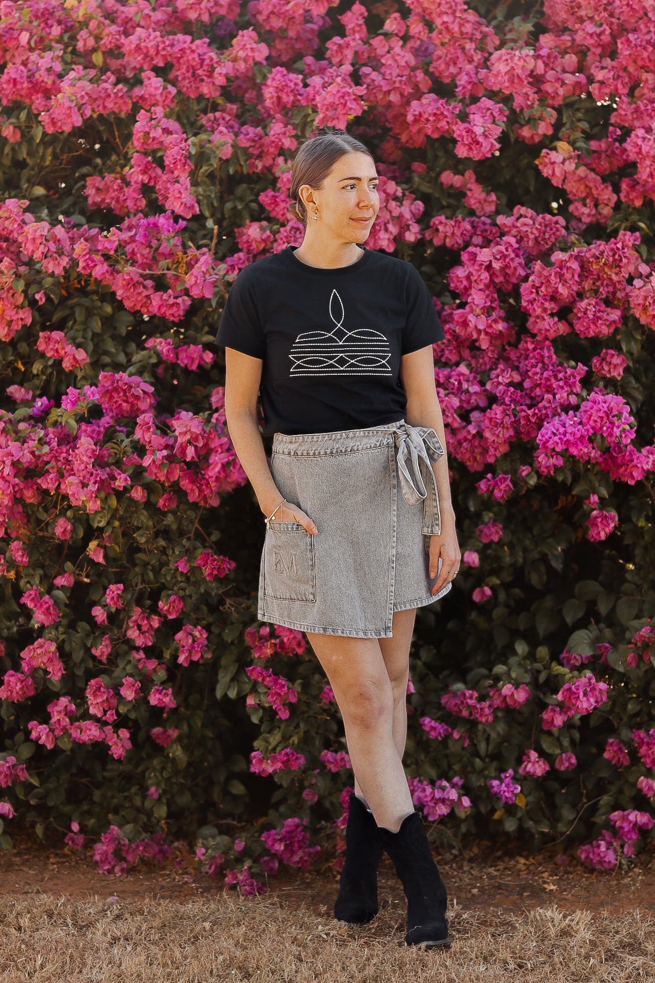 Mum posing for a photo wearing a boot stitch print tittytees breastfeeding shirt outdoors
