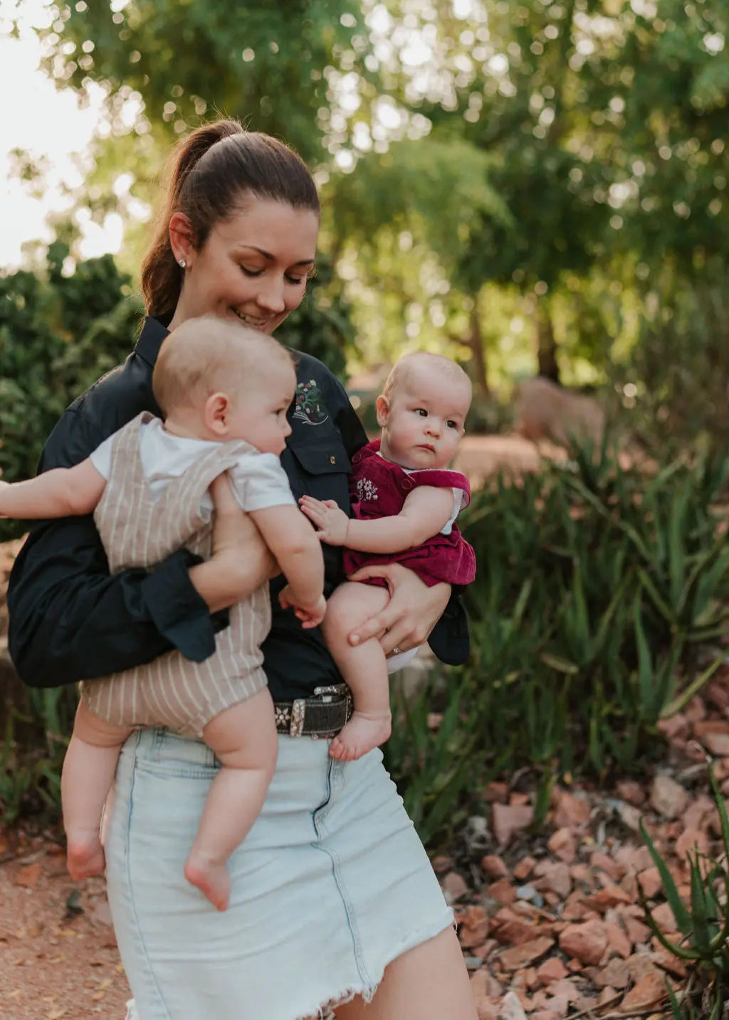 Mum holding twins in long sleeve tittytees shirt.