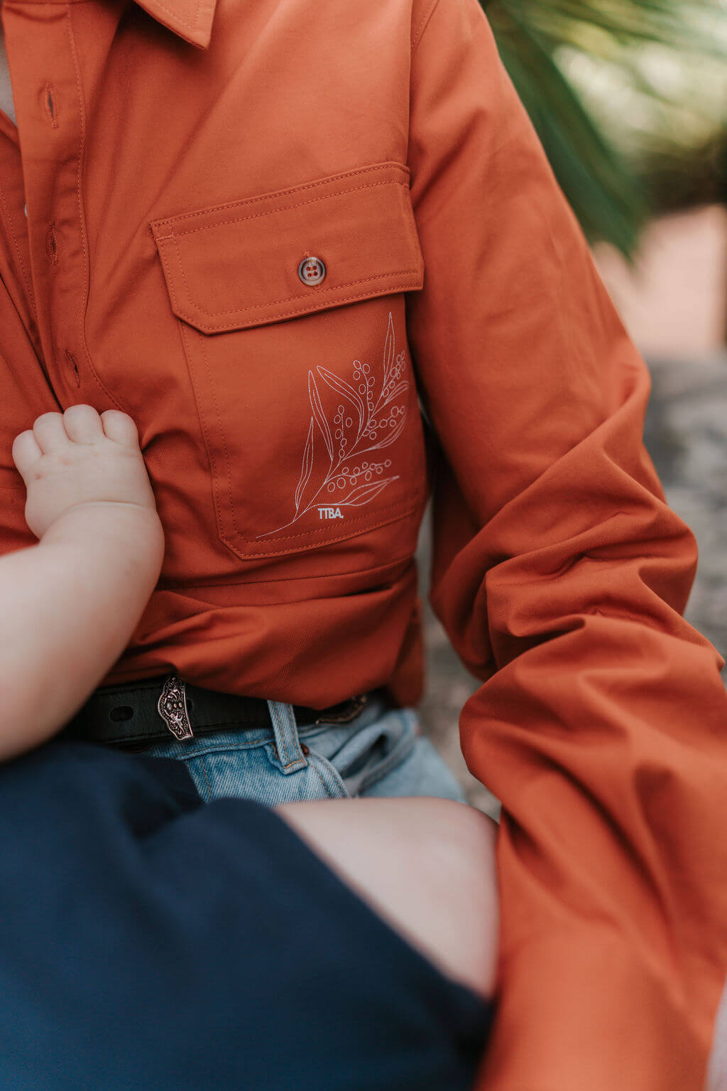 Close up of native print on long sleeve breastfeeding shirt pocket 