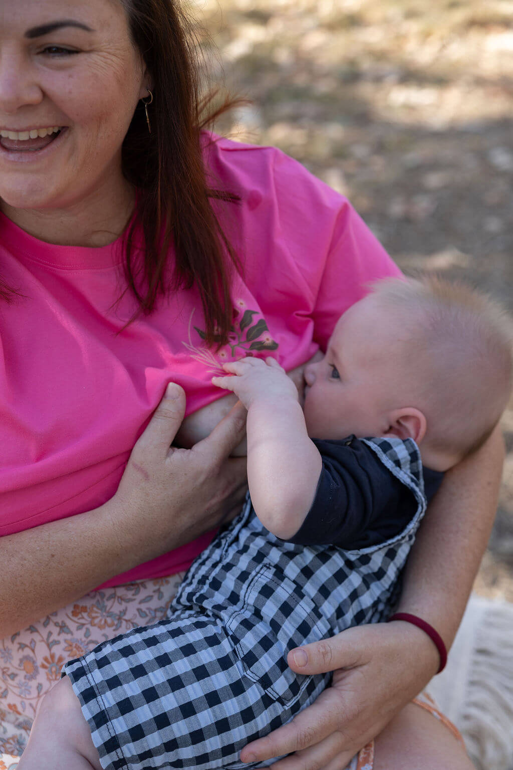Mum breastfeeding baby in TittyTees pink Gumnuts tee
