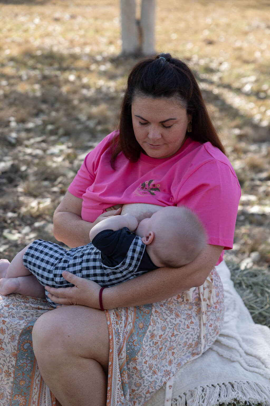 Mum breastfeeding baby outdoors 