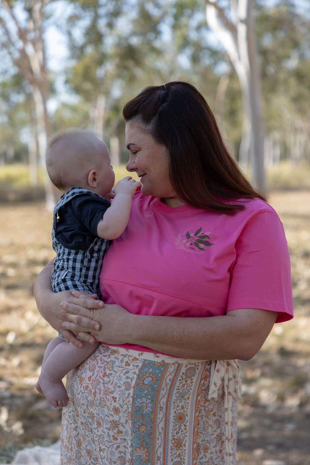 Mum looking at baby modelling breastfeeding friendly shirt by TittyTees 