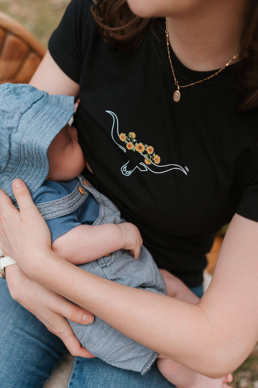 Mum nursing baby wearing black nursing tee