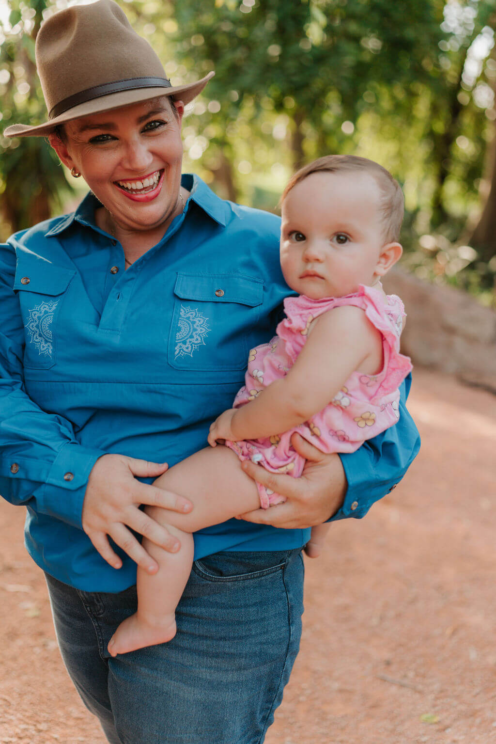Mum holding baby while wearing Mandala Breastfeeidng shirt 