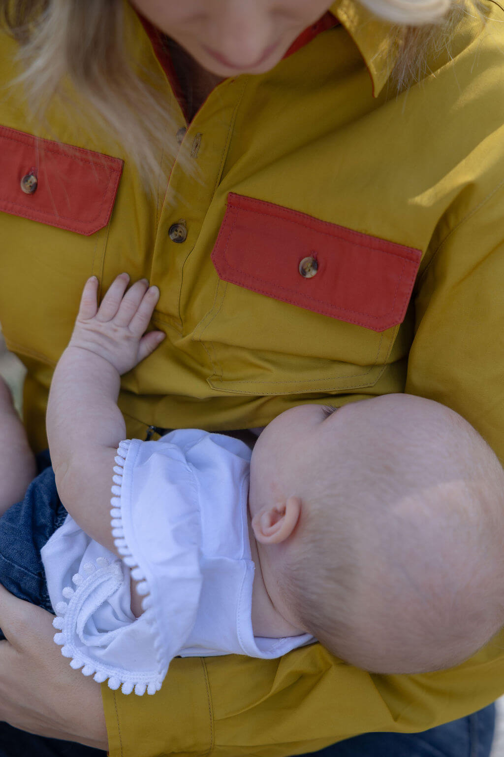 Mum breastfeeding a baby outdoors 