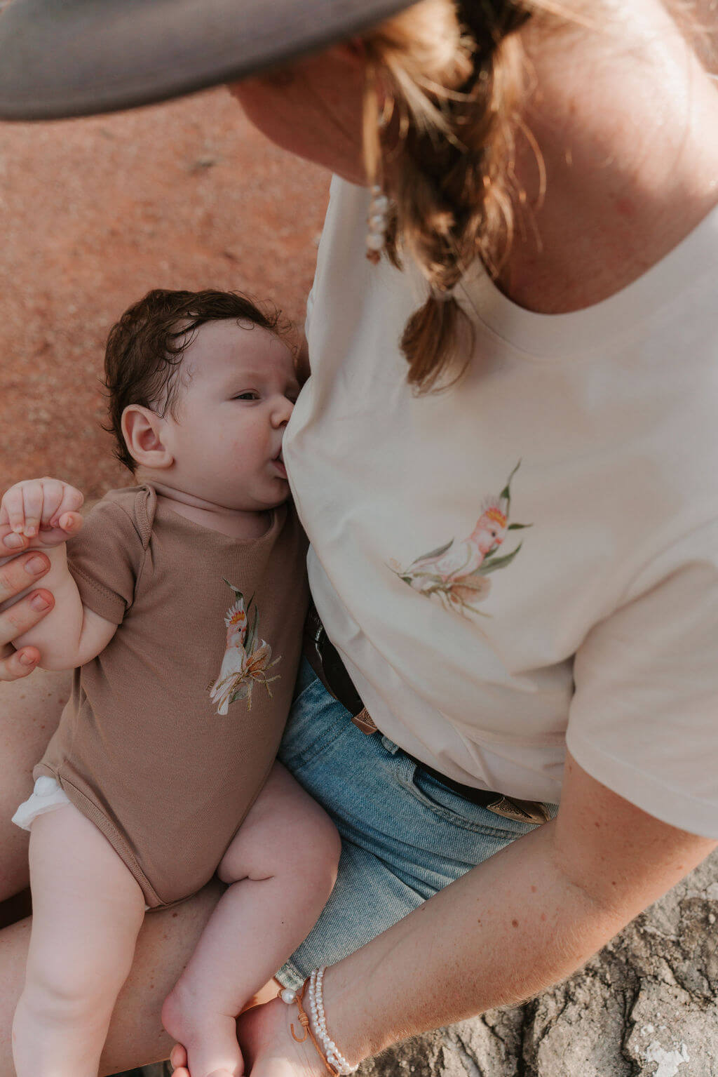 Mum breastfeeding baby wearing ivory tee with Australian print 
