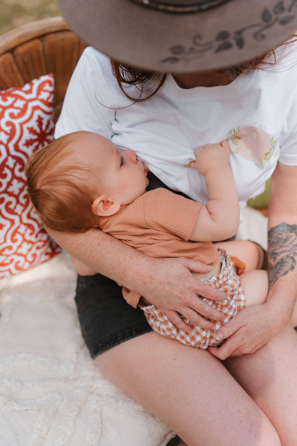 Baby nursing and mum wearing white Yin & Yang TittyTees shirt