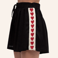 Black high waist maternity shorts with a red heart pattern on a white background