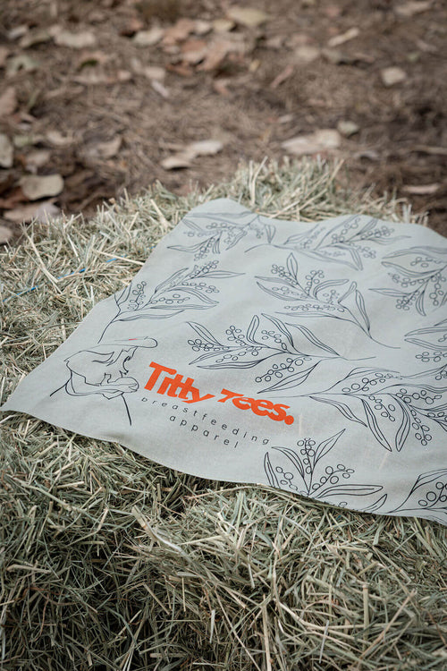 100% cotton bandana green laying on a hay bale